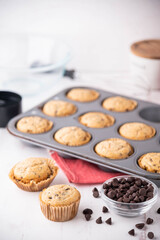 chocolate chip muffin on white wooden board