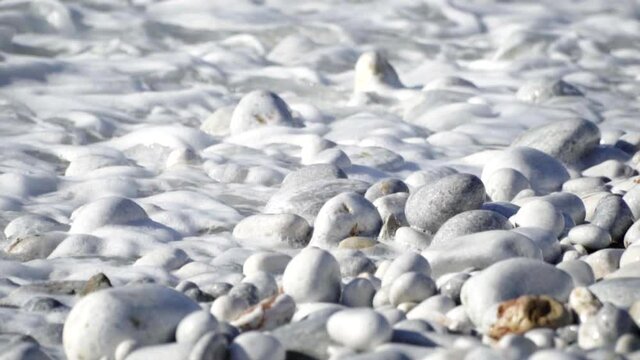 Pebble Beach With Foamy Sea Waves During SUmmer In Greece.  - medium shot