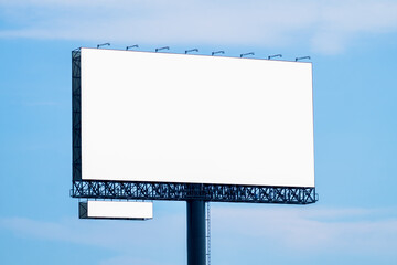 Blank billboard mockup with white screen against clouds and blue sky background. Copy space banner for advertisement