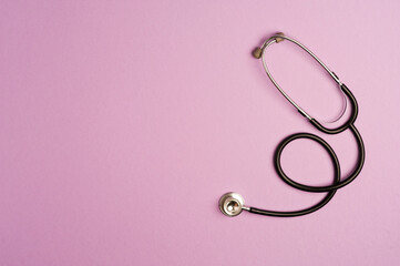 Medicine accessory, stethoscope, lilac background with copy space. top view