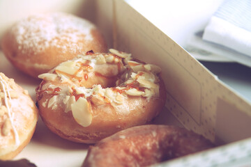 Assorted donuts with different fillings in cardboard box