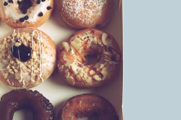 Assorted donuts with different fillings in cardboard box