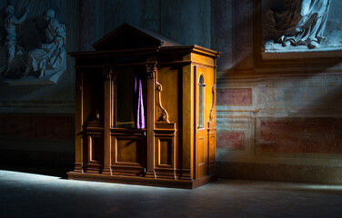 Wooden confessional in the old church in the sunlights