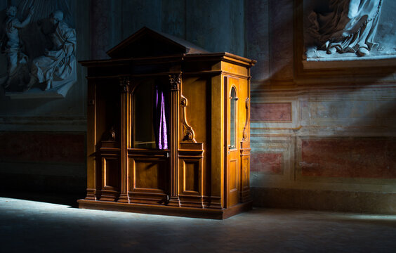 Wooden confessional in the old church in the sunlights