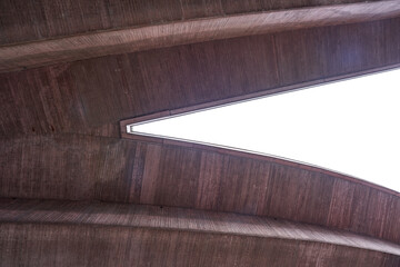 Fork of a viaduct in reddish color, photographed from below with a wide angle. Stuttgart.