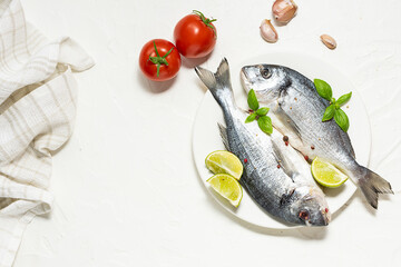 Fresh raw dorado fish with spices and herbs on white background with copy space for your text. Fish market banner. 