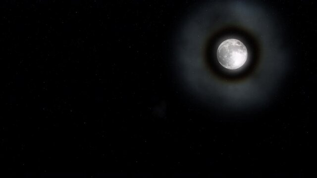 A big bright halo around the moon as viewed on a clear starry night.
