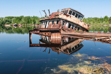 Abandoned sunken Barges Boats On River Pripyat in Chernobyl exclusion Zone. Chernobyl Nuclear Power...