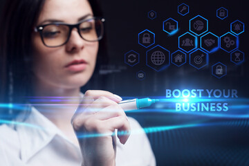 Business, Technology, Internet and network concept. Young businessman working on a virtual screen of the future and sees the inscription: Boost your business