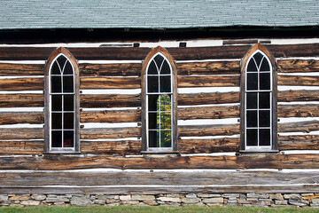 Side view of the detail of the weathered wooden log cabin church.
