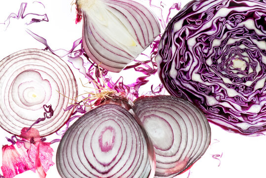 Fresh sliced red onions and red cabbage on white background