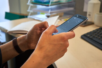 Person is typing text on their smatphone 