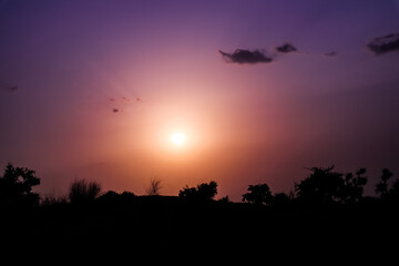 The beautiful sunset, colourful sky, green trees.