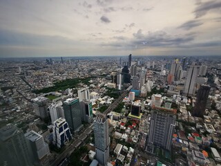 Top view aerial from the tallest skyscraper building of the metropolitan  Bangkok, Thailand with modern architectural building and beautiful river  in the evening sunset time. 