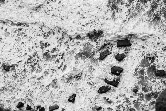 From above of dashing powerful waves of dark ocean with white foam in Ireland