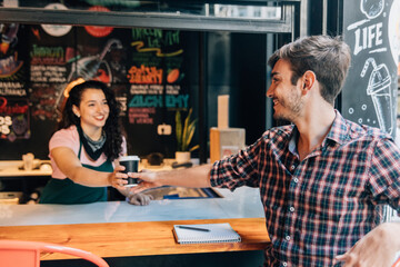 Bartender handing drink to a customer