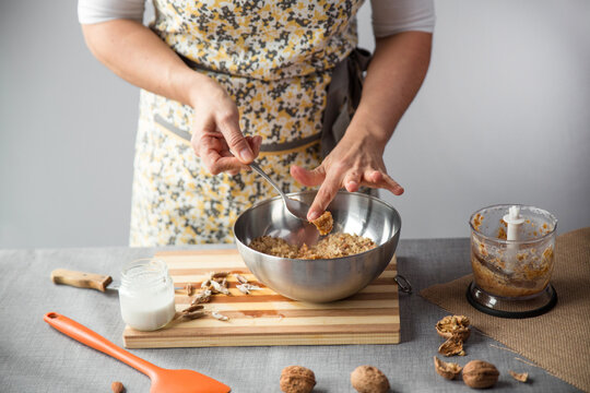 Woman adding blender mixture into a bowl