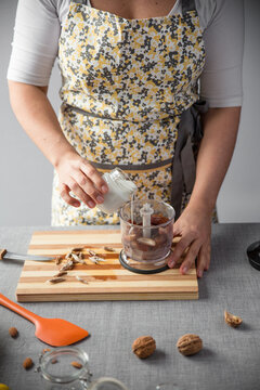 Woman pouring cream into a blender