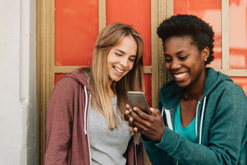 Two girls laughing a phone