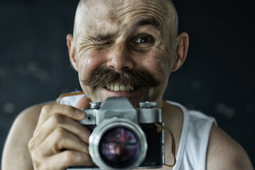 photographer with a vintage analog camera, a man with mustache, funny image learning photography