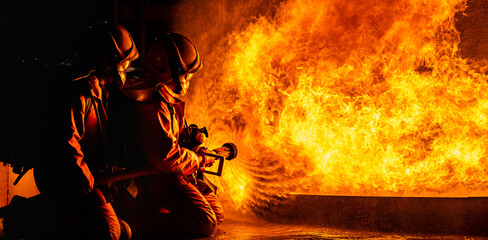 Firefighters use twirl water fog spraying down fire flame. - obrazy, fototapety, plakaty