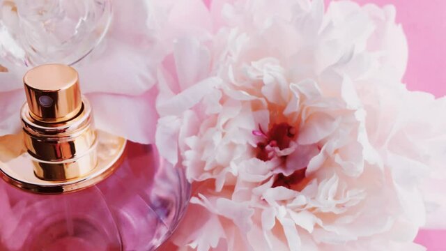 Pink perfume bottle with peony flowers, chic fragrance scent as luxury cosmetic, fashion and beauty product backgrounds