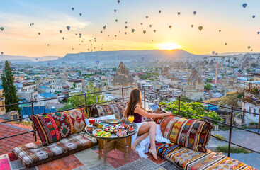 Breakfast on the roof with amazing view on Cappadocia, Turkey. Morning sunrise, when hot balloons...