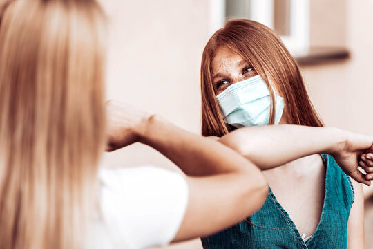 Elbow bump between mother and daughter. Corona virus protection measures