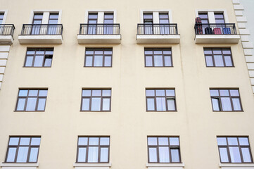 Direct view of the facade of a modern apartment building with balconies.