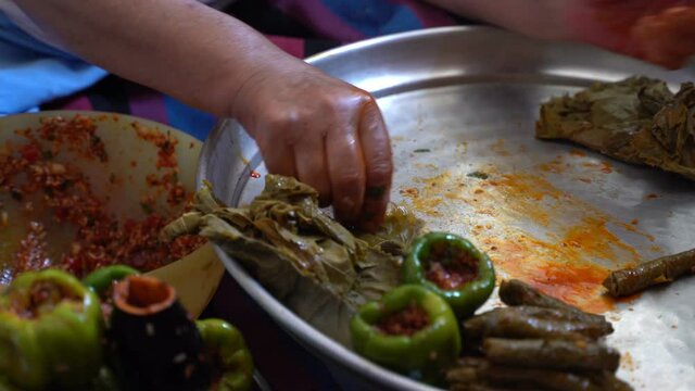 A woman is preparing stuffed grape leaves, leaf wrap, Turkish food culture and stuffed leaves
