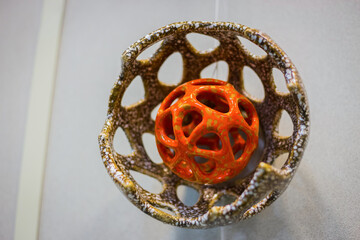 Unusual glaze ceramic hanging decor on earthenware exhibition - close up view. Handmade, decoration, art and handicraft concept