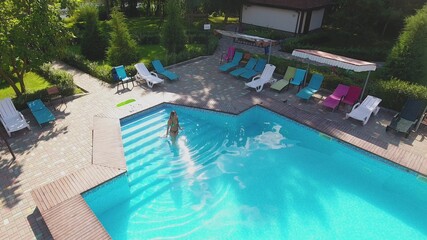 Top of view of aerial flying drone view of swimming pool in resort