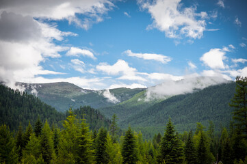 Fototapeta na wymiar Sunlight falling on the Altai Mountains through the clouds