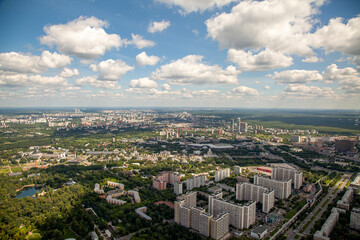 Fototapeta na wymiar Office buildings and apartment buildings rise above the city streets of Moscow, Russia as seen from an aerial view.