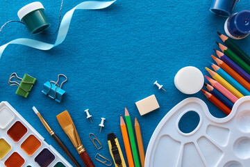 Art materials, products for drawing. Stationery set on blue background