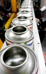 empty aerosol cans awaiting filling in production factory