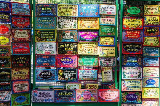 BUENOS AIRES, ARGENTINA - FEBRUARY 24, 2016: Funny spanish door welcoming boards on La Boca market in Buenos Aires district.