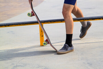 Fototapeta na wymiar Young man practising on skateboard in skate park