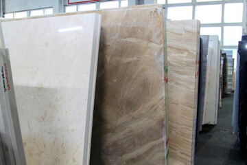 Colorful marble slabs in store show room. Granite slabs are prepared for sale in store yard