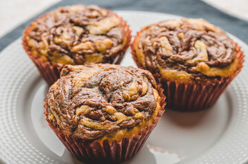 Freshly Baked Banana Chocolate Walnut Muffin on White Plate- Top View