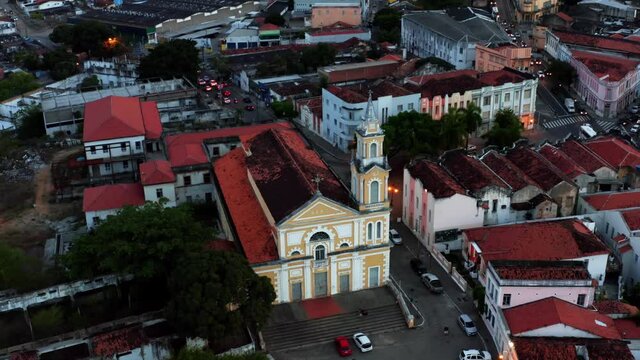 Beautiful aerial descending drone shot approaching a historical cathedral in the heart of the downtown of the tropical city of Joao Pessoa in Northern Brazil on a warm summer evening.