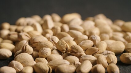 Tasty pistachios nuts isolated on black background.