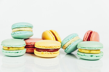 Sweet almond colorful pastel pink blue yellow green macaron or macaroon dessert cake isolated on white background. French sweet cookie. Minimal food bakery concept Copy space