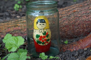 Matryoshka doll in a glass jar.