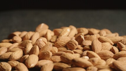 Macro shot of Almonds lays on black desk