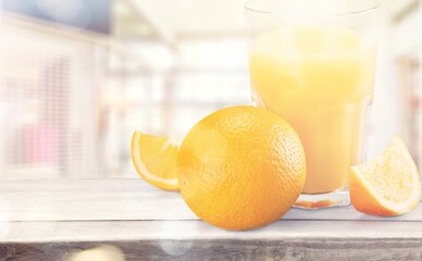 Orange juice and slices of orange on wooden desk © BillionPhotos.com
