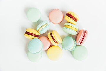 Sweet almond colorful pastel pink blue yellow green macaron or macaroon dessert cake isolated on white background. French sweet cookie. Minimal food bakery concept. Flat lay top view, copy space
