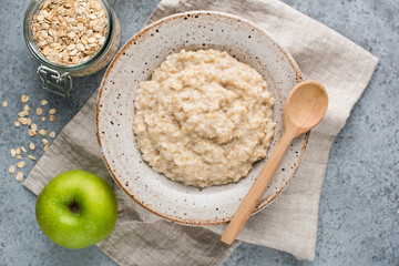 Oatmeal porridge in bowl, healthy breakfast food, top view