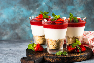 Cheesecake in the glasses with fresh strawberry.