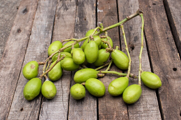 Spondias Mombin or Hog Plum  Isolated on Wooden Background